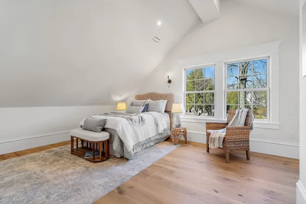 a spacious bedroom with a bed and a window