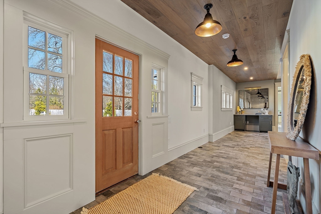 16 Hatch Farm Lane, Unit 16 Concord, MA 01742 - Photo 3 of 39 a view of a hallway with wooden floor and a kitchen