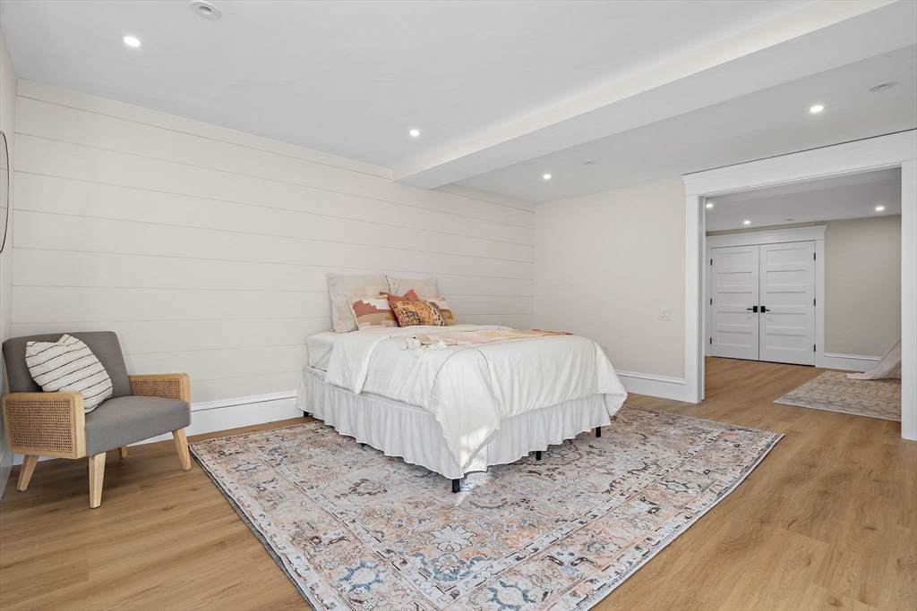 16 Hatch Farm Lane, Unit 16 Concord, MA 01742 - Photo 32 of 39 a bedroom with a bed and a table