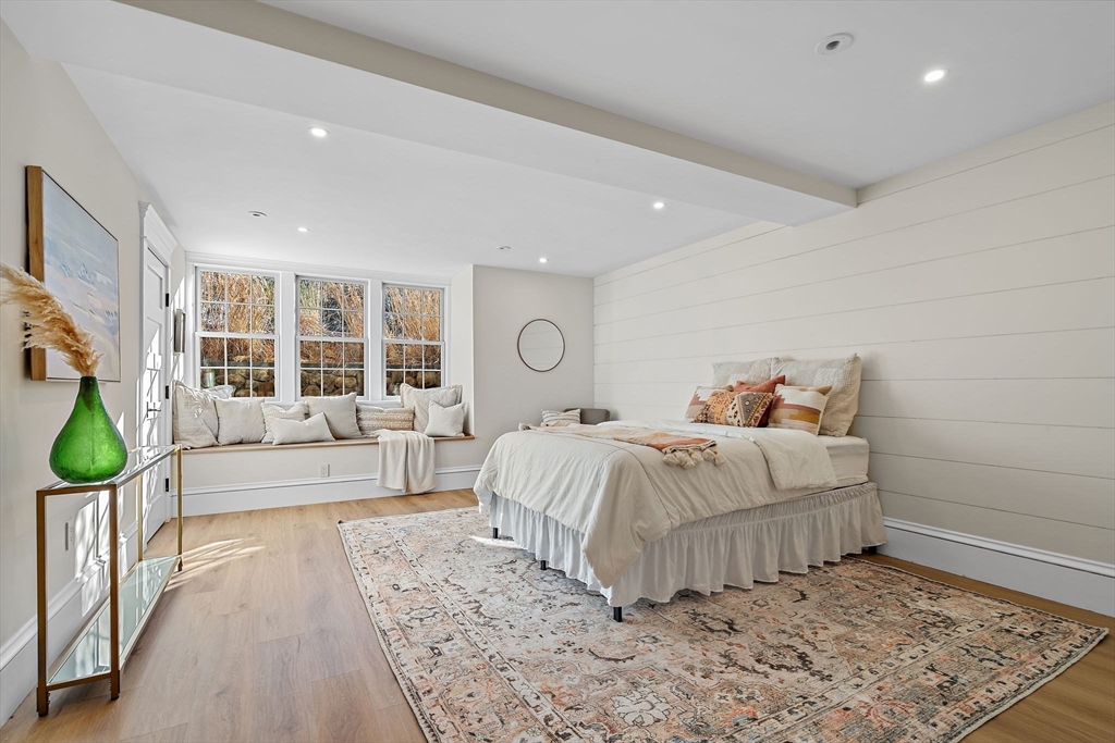 16 Hatch Farm Lane, Unit 16 Concord, MA 01742 - Photo 33 of 39 a bedroom with a large bed and a couch