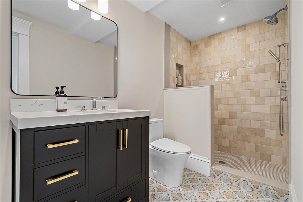 16 Hatch Farm Lane, Unit 16 Concord, MA 01742 - Photo 36 of 39 a bathroom with a sink a toilet and shower