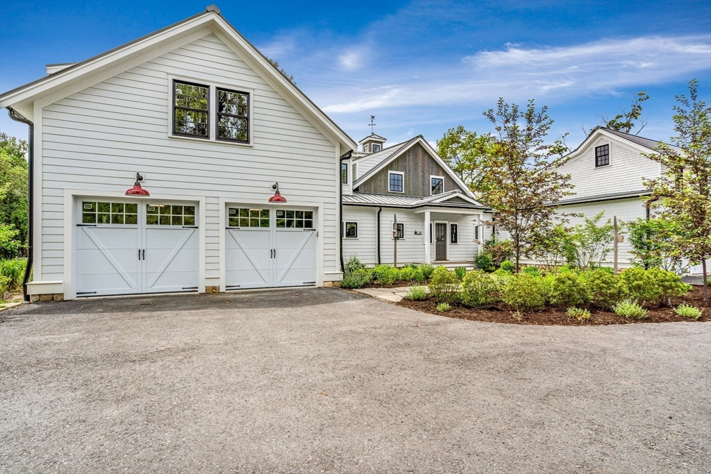 16 Hatch Farm Lane, Unit 16 Concord, MA 01742 - Photo 39 of 39 a front view of a house with a yard and garage