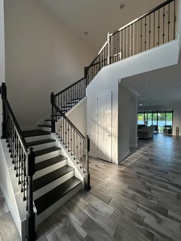 a living room with lots of furniture and kitchen view