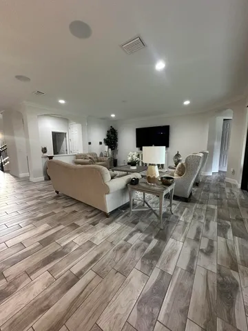 a living room with furniture and a chandelier