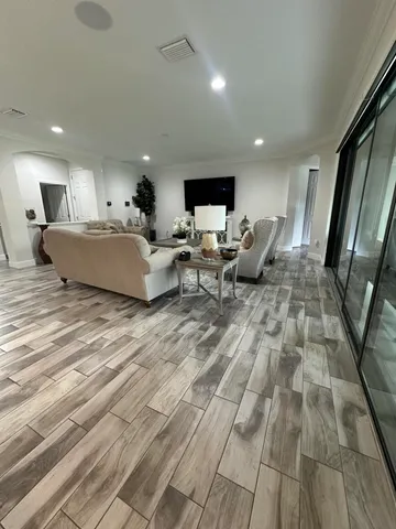 a living room with furniture and a floor to ceiling window