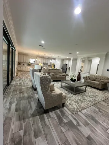 a view of a house with a yard potted plants and large tree