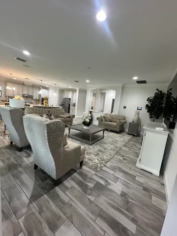 a living room with patio furniture and a potted plant