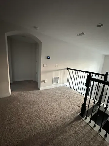 a view of walk in closet with clothes