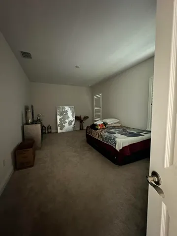 a view of a big room with table and chairs under an umbrella