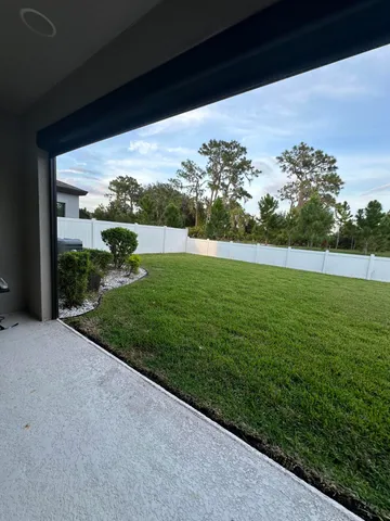 an aerial view of a house with yard swimming pool and outdoor seating