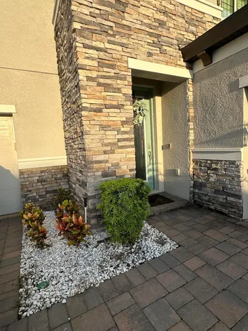 a dining room with furniture a rug and a chandelier