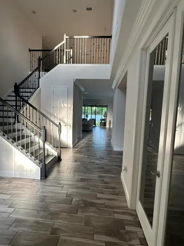 a view of staircase with railing and white walls