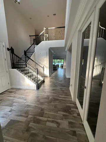 a dining room with furniture a rug and a chandelier