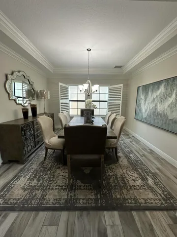 a living room with lots of furniture and kitchen view