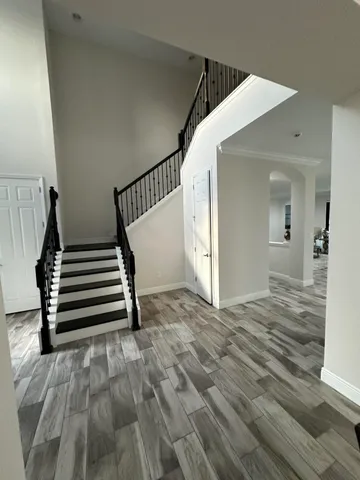 a kitchen with kitchen island granite countertop a sink dining table and chairs