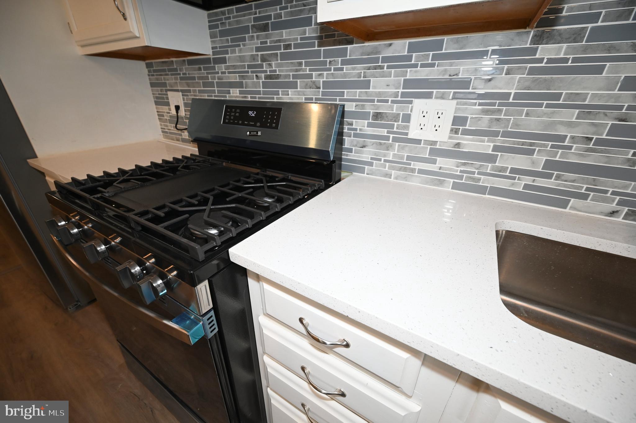 2952 Sollers Point Road, Unit B Dundalk, MD 21222 - Photo 26 of 37 a stove top oven sitting inside of a kitchen