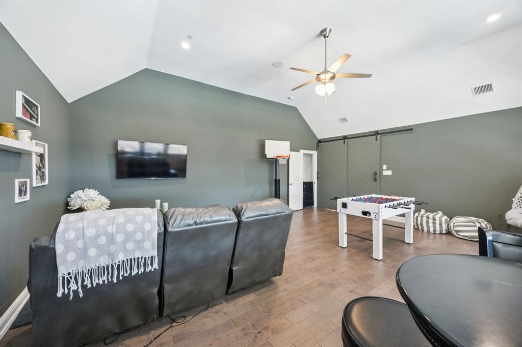330 Bonham Boulevard Fairview, TX 75069 - Photo 19 of 32 a living room with furniture and a flat screen tv