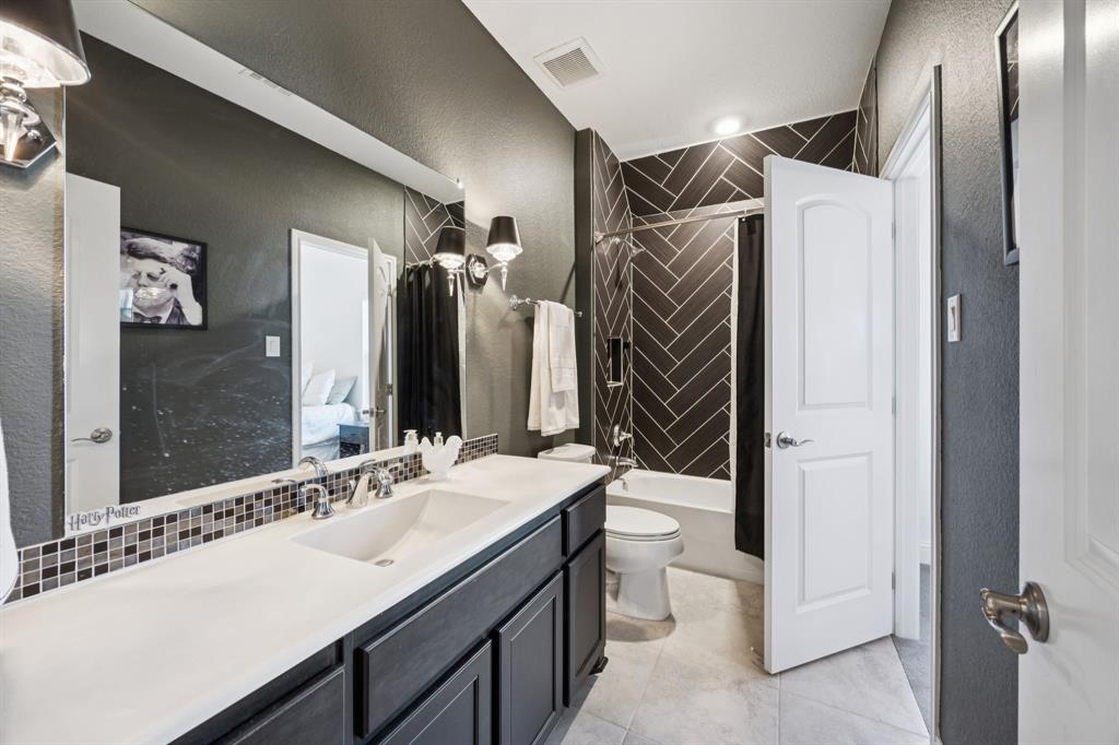 330 Bonham Boulevard Fairview, TX 75069 - Photo 21 of 32 a bathroom with a sink double vanity and a mirror