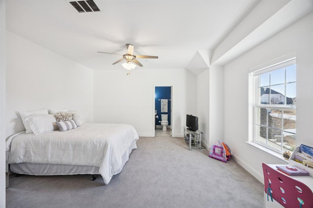 330 Bonham Boulevard Fairview, TX 75069 - Photo 22 of 32 a bedroom with a bed and a chandelier