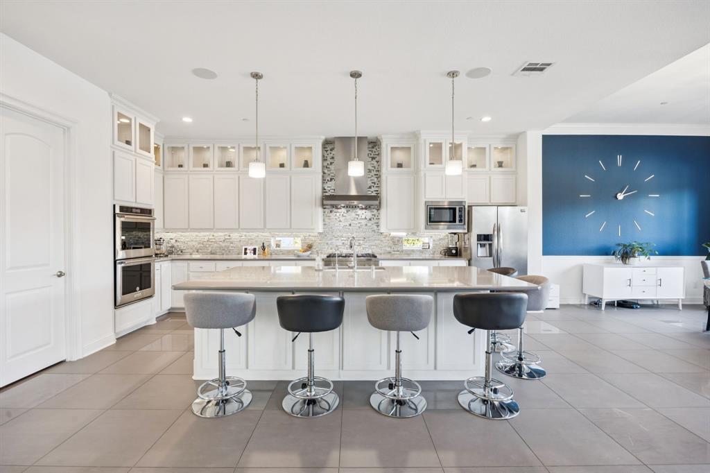 330 Bonham Boulevard Fairview, TX 75069 - Photo 10 of 32 a kitchen with a dining table and chairs