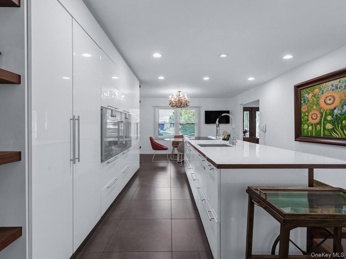 15 Fairway Circle South, Unit 15 Manhasset, NY 11030 - Photo 13 of 39 Kitchen with white cabinetry, recessed lighting, open shelves, dark tile patterned flooring, and a kitchen island with sink