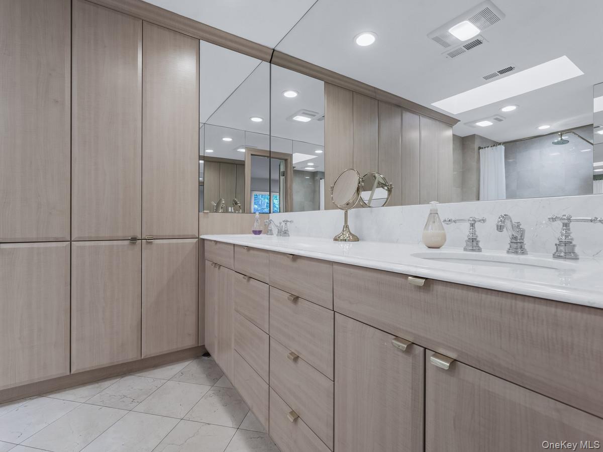 15 Fairway Circle South, Unit 15 Manhasset, NY 11030 - Photo 21 of 39 First Floor Primary Bathroom featuring double vanity, a shower, and recessed lighting