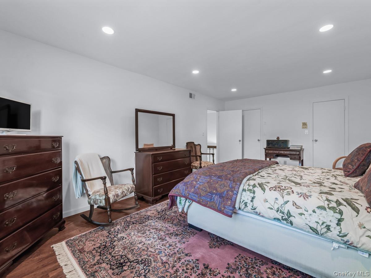 15 Fairway Circle South, Unit 15 Manhasset, NY 11030 - Photo 27 of 39 Second Floor Bedroom featuring dark wood-type flooring and recessed lighting
