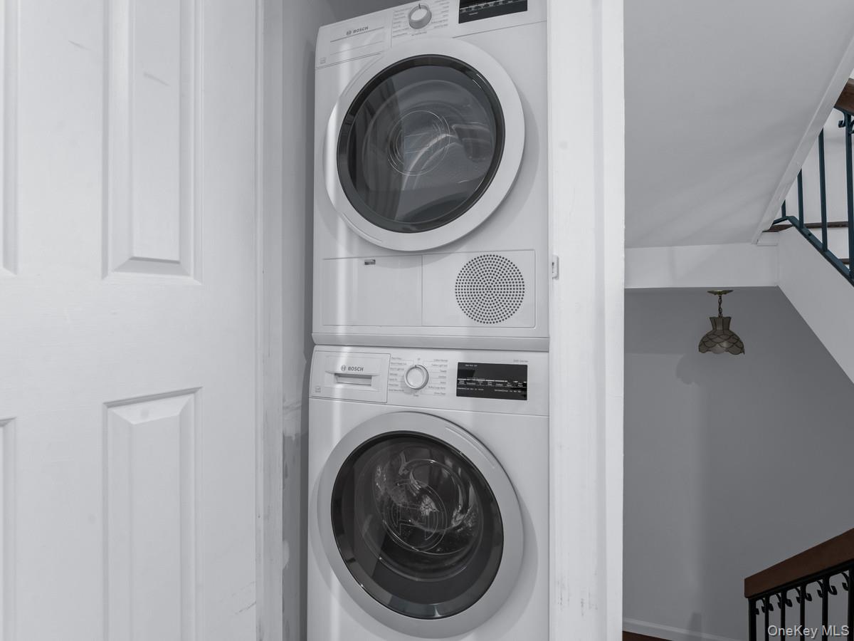 15 Fairway Circle South, Unit 15 Manhasset, NY 11030 - Photo 29 of 39 First Floor Laundry closet featuring stacked washer / drying machine