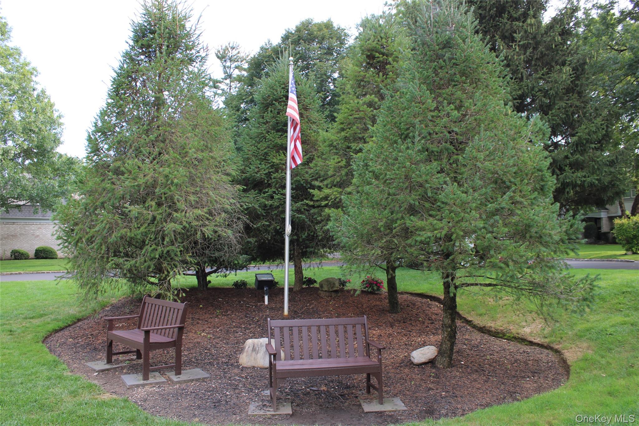 15 Fairway Circle South, Unit 15 Manhasset, NY 11030 - Photo 36 of 39 View of community with a flagpole and benches