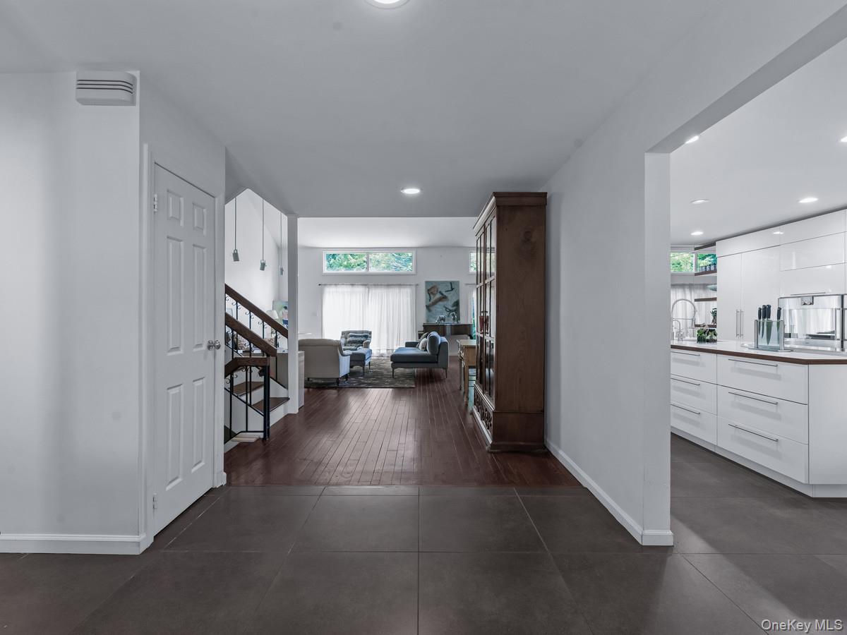 15 Fairway Circle South, Unit 15 Manhasset, NY 11030 - Photo 6 of 39 Hall with stairway, recessed lighting, and dark tile patterned flooring