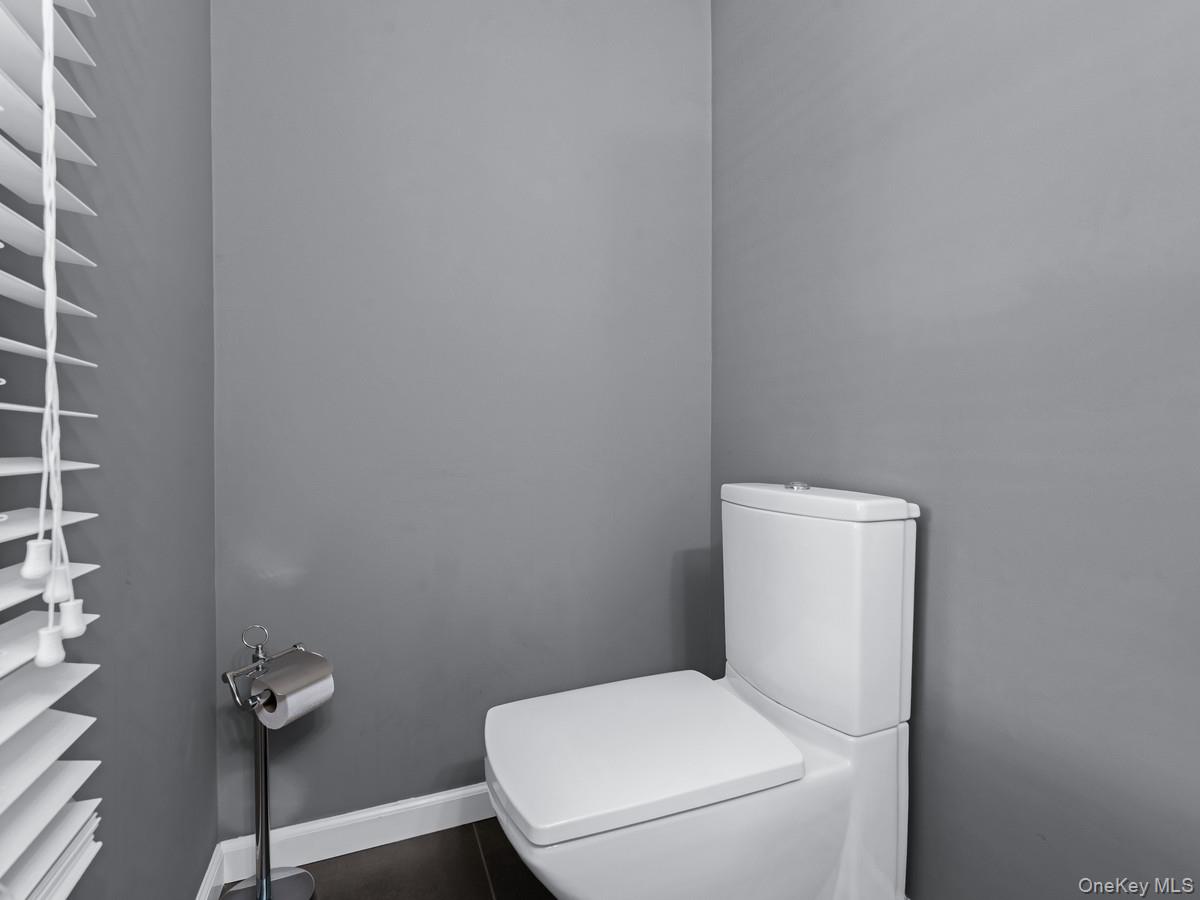 15 Fairway Circle South, Unit 15 Manhasset, NY 11030 - Photo 8 of 39 Powder Room; Half Bathroom featuring toilet and baseboards