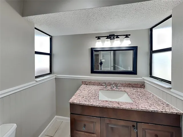 a view of a hallway view with mirror and window