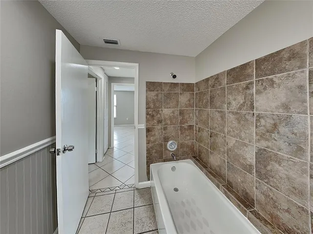 a bathroom with a tub a sink and a shower