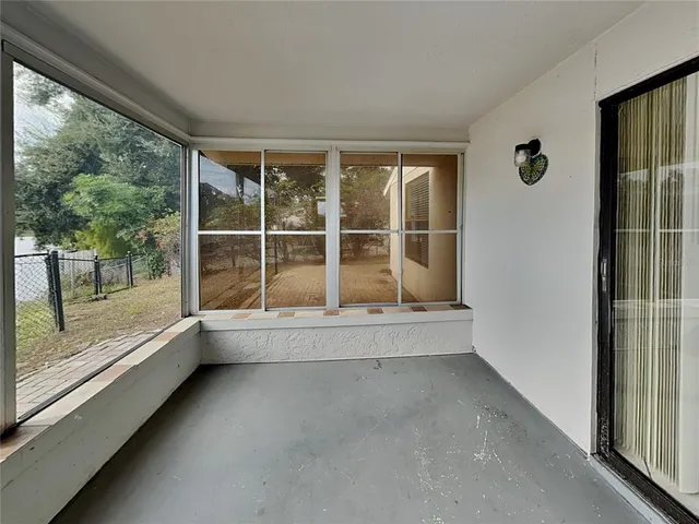 en empty room with sliding glass door and wooden floor