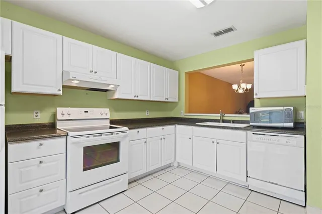 a kitchen with cabinets appliances and a sink