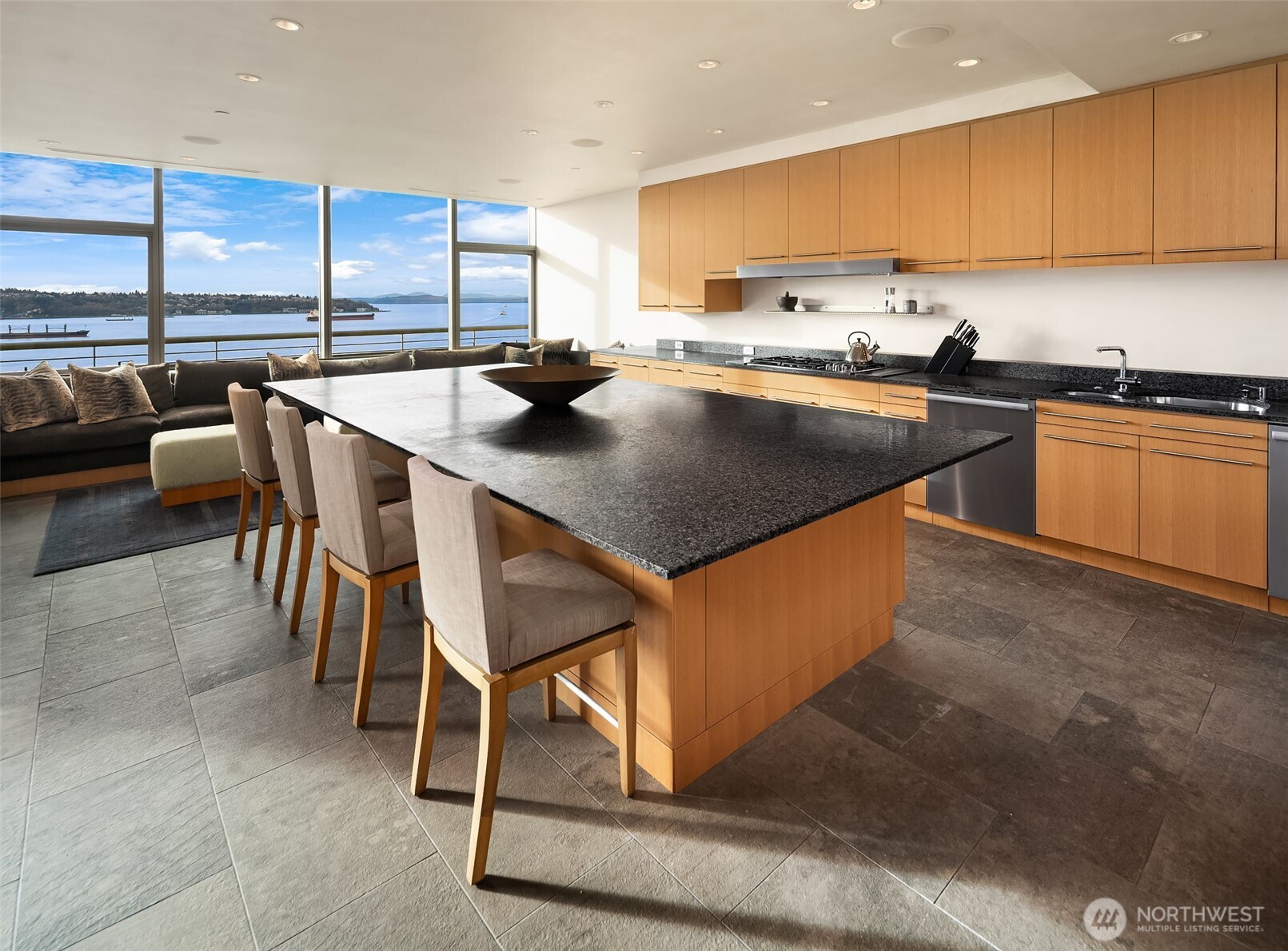 715 2nd Avenue, Unit 1501 Seattle, WA 98104 - Photo 13 of 40 a kitchen with a table chairs sink and cabinets