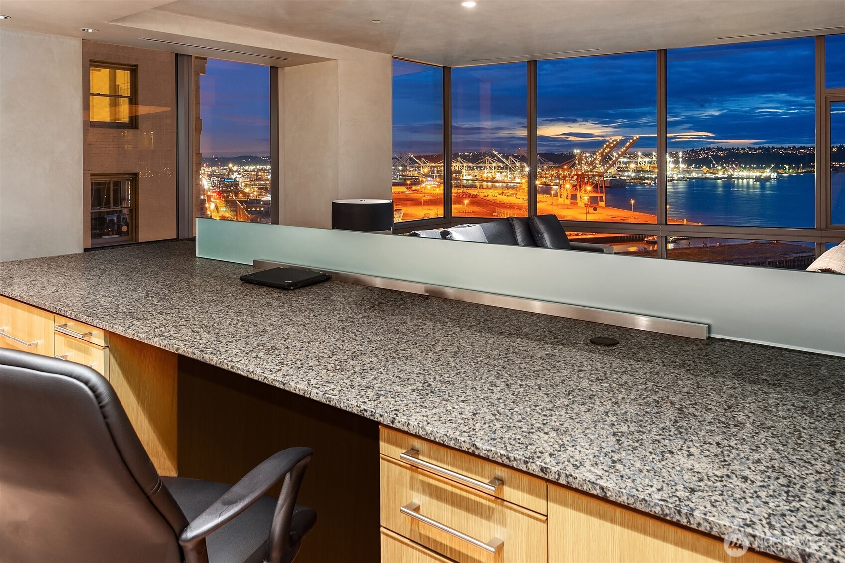 715 2nd Avenue, Unit 1501 Seattle, WA 98104 - Photo 19 of 40 a kitchen with cabinets and chairs