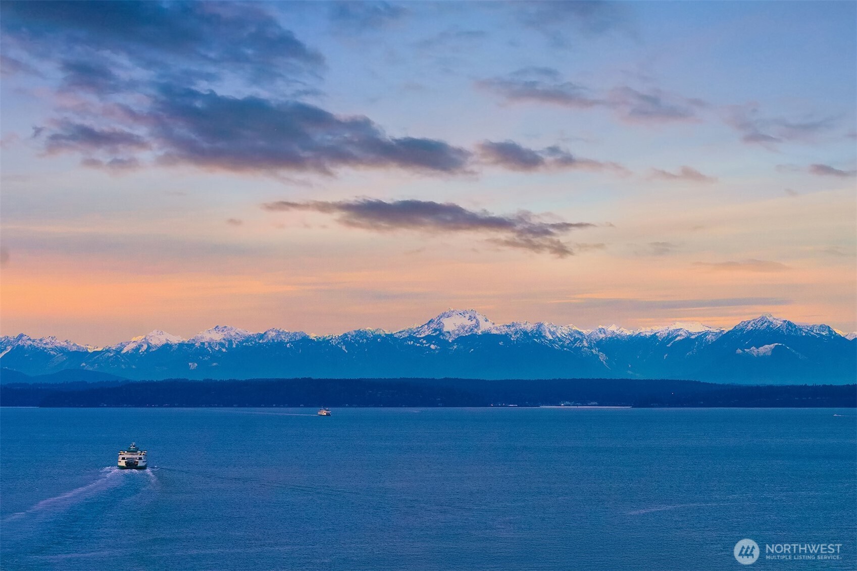 715 2nd Avenue, Unit 1501 Seattle, WA 98104 - Photo 2 of 40 a view of an ocean and a mountain