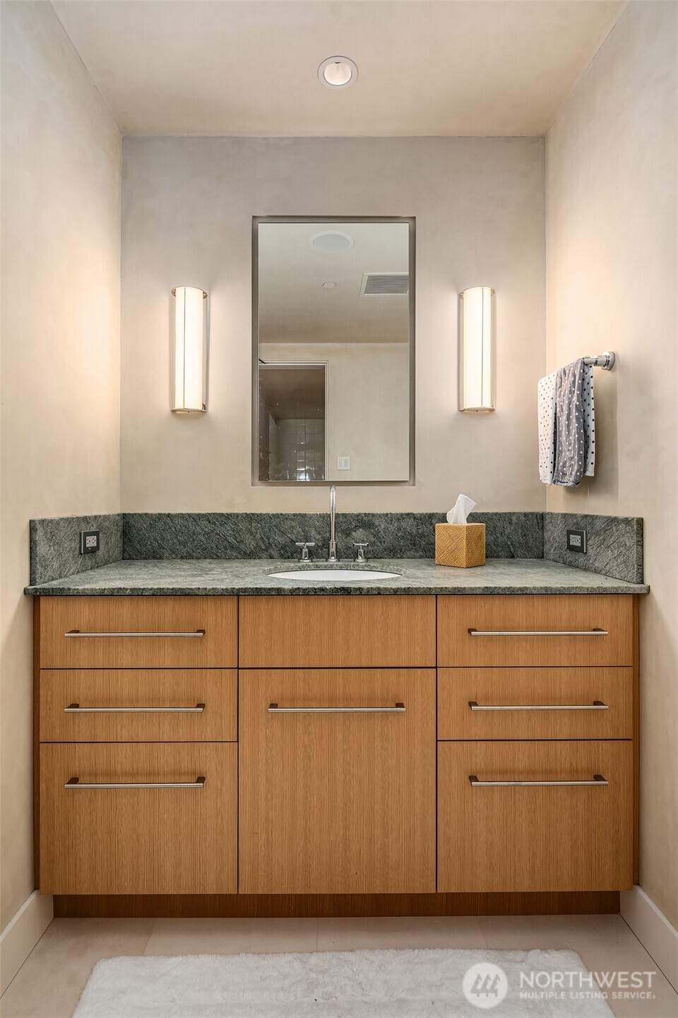 715 2nd Avenue, Unit 1501 Seattle, WA 98104 - Photo 27 of 40 a bathroom with a granite countertop sink and a mirror