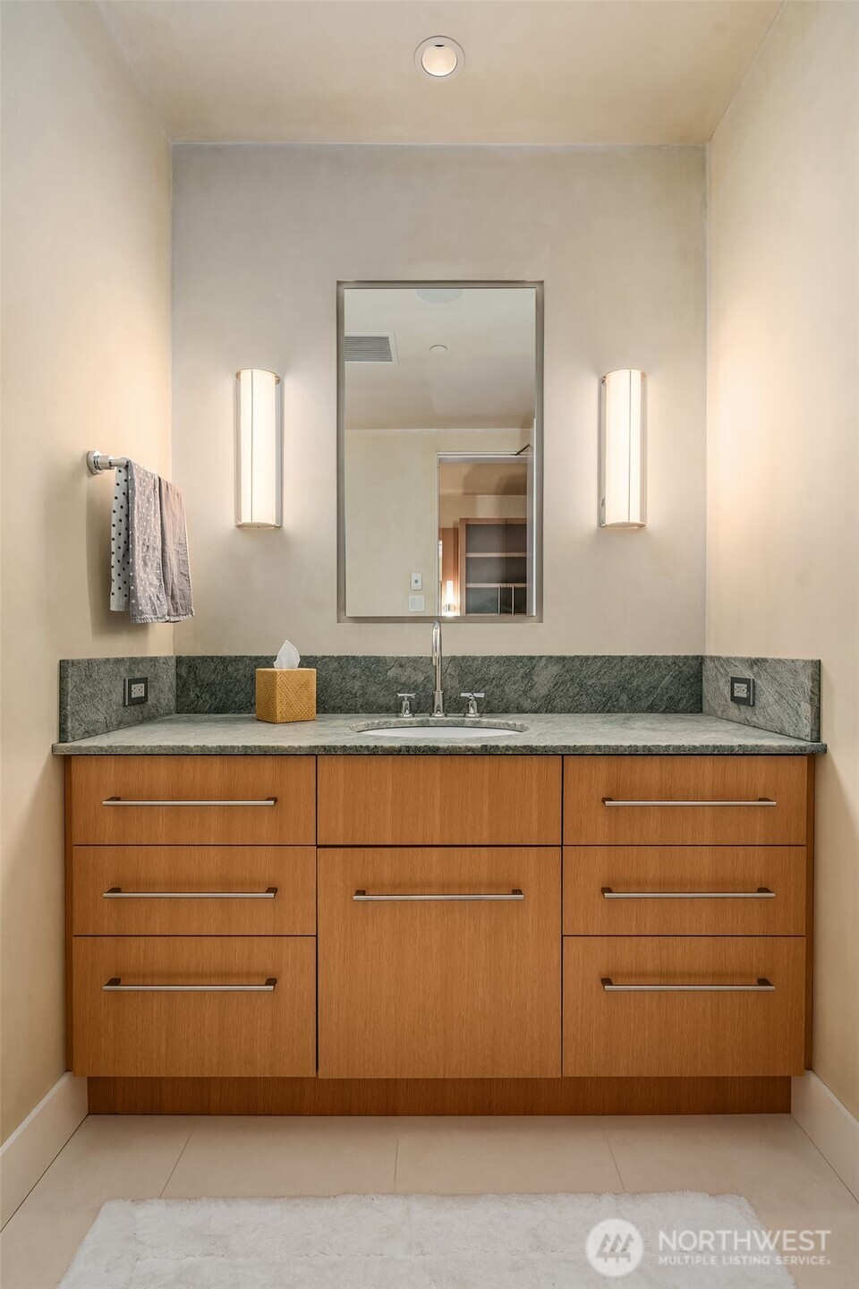 715 2nd Avenue, Unit 1501 Seattle, WA 98104 - Photo 28 of 40 a bathroom with a granite countertop sink and a mirror