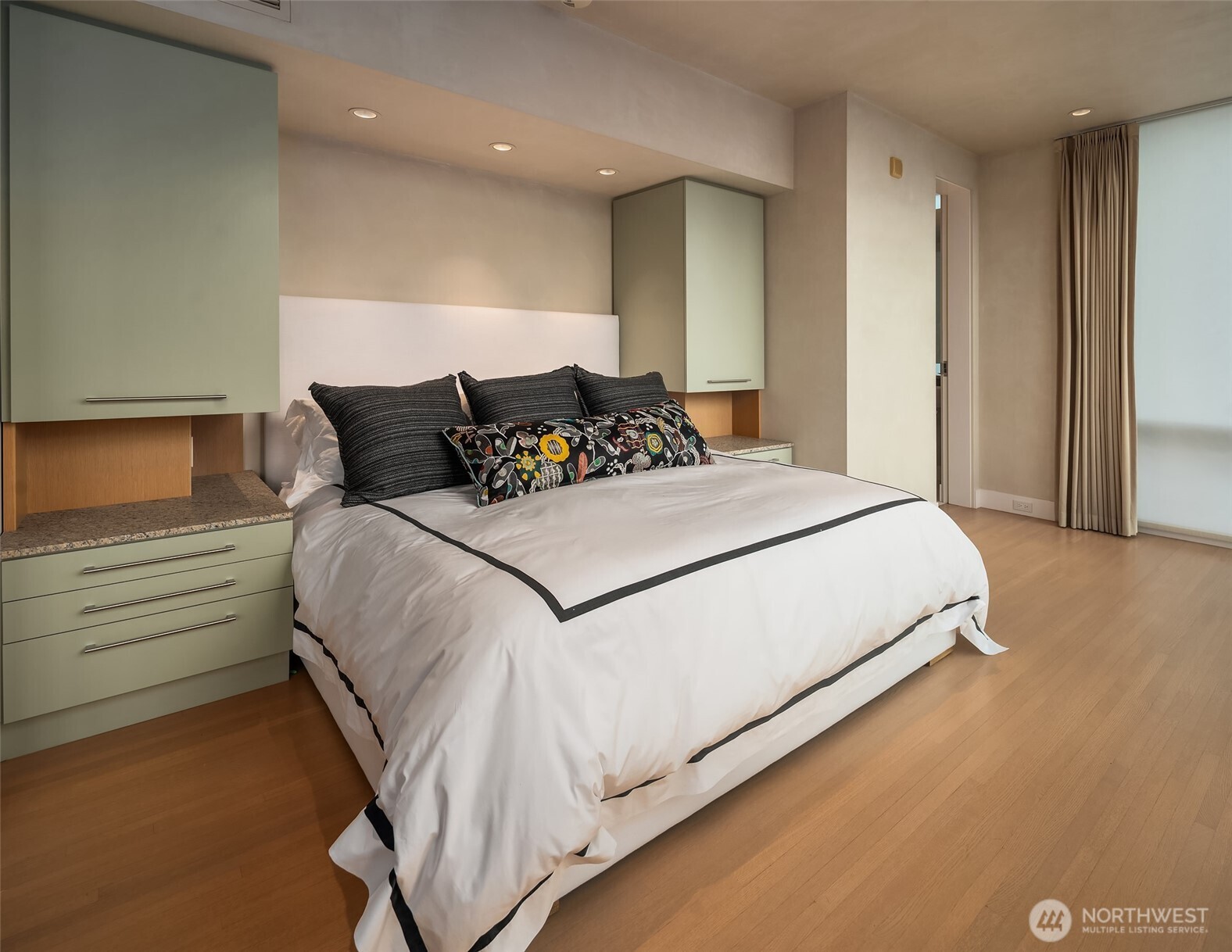 715 2nd Avenue, Unit 1501 Seattle, WA 98104 - Photo 32 of 40 a large bed sitting in a large bedroom next to a cabinet