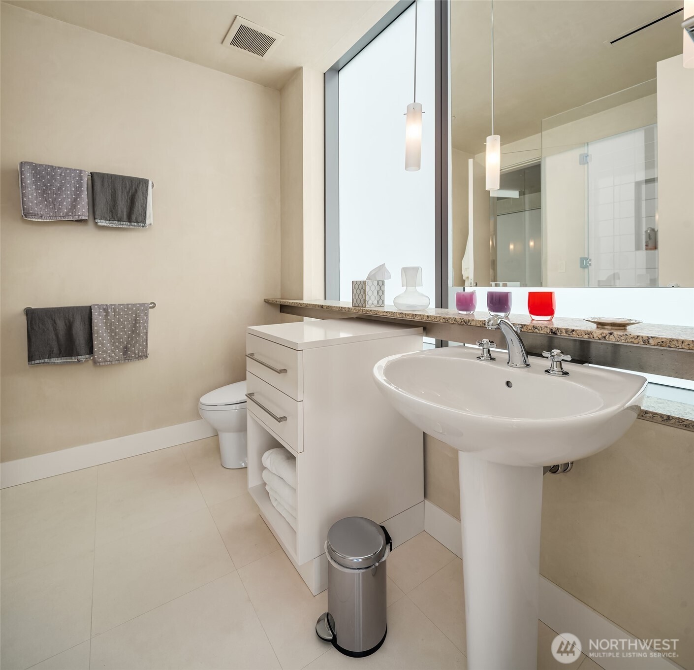 715 2nd Avenue, Unit 1501 Seattle, WA 98104 - Photo 33 of 40 a bathroom with a sink toilet and mirror