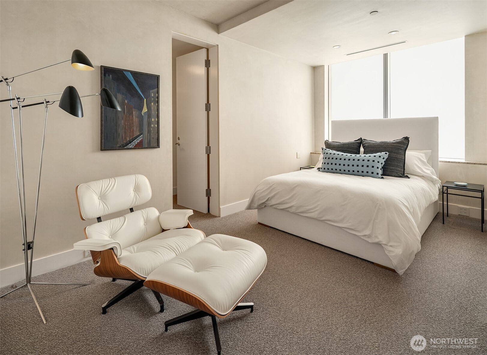 715 2nd Avenue, Unit 1501 Seattle, WA 98104 - Photo 35 of 40 a bedroom with a bed and a chair