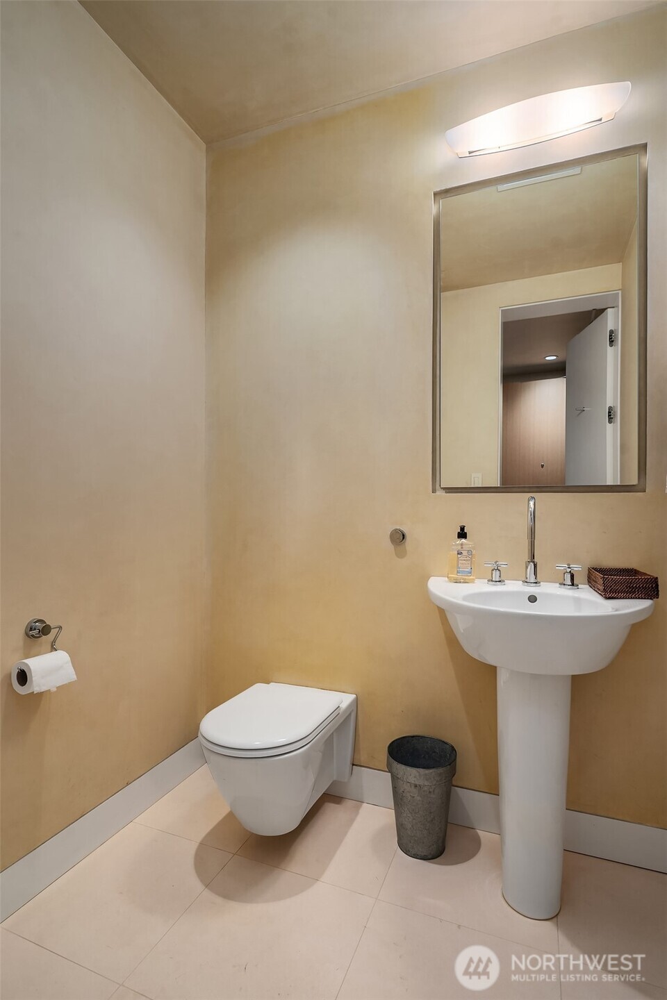 715 2nd Avenue, Unit 1501 Seattle, WA 98104 - Photo 36 of 40 a bathroom with a toilet sink and mirror