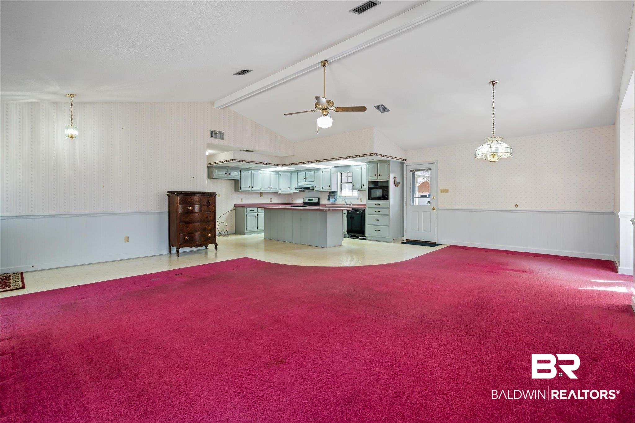 6030 Lott Road Eight Mile, AL 36613 - Photo 4 of 21 Unfurnished living room with lofted ceiling with beams, visible vents, baseboards, wallpapered walls, and ceiling fan