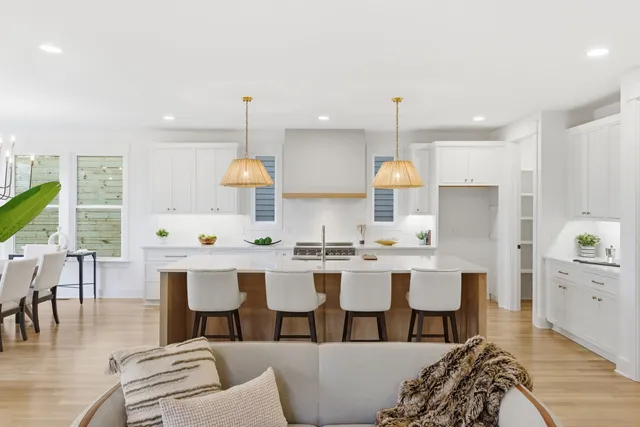 a kitchen with a white center island and cabinets