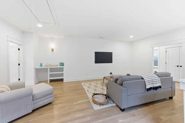 a bedroom with a large bed and windows