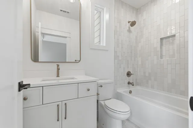 a view of a room with wooden floor and a bathroom