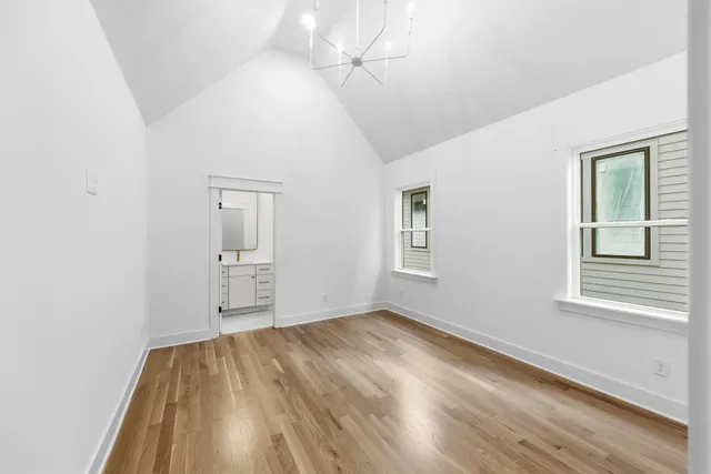 a bathroom with a toilet a sink a mirror a bathtub and vanity