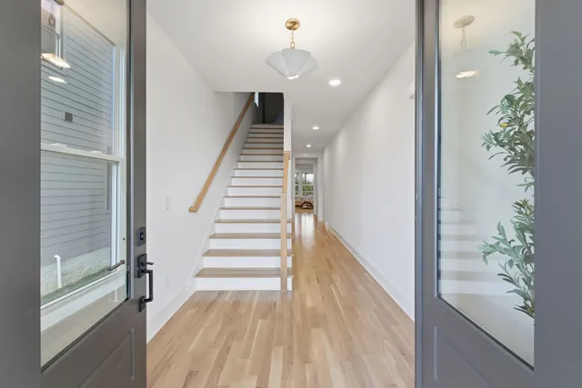 a view of an entryway with wooden floor